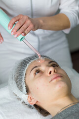 Violet ray treatment on face at the beautician.