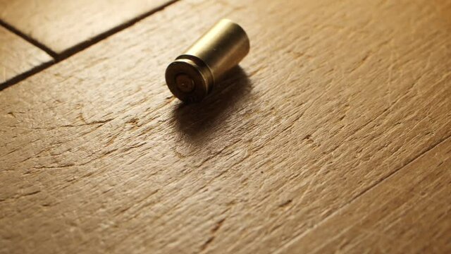 Bullet casing falls on the floor in slow motion, 3 different shots, 9 mm handgun ammo