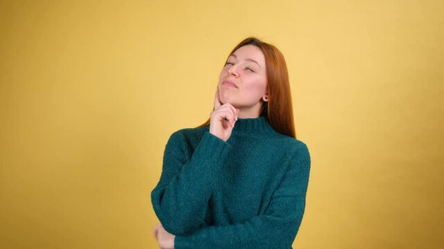 Need to think. Pensive doubting woman pondering and imagining in mind, wondering difficult solution, feeling confused, not sure about choice. studio shot isolated on yellow background