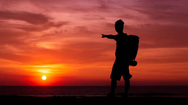 Man on the sunset after help baby turttles go to the ocean