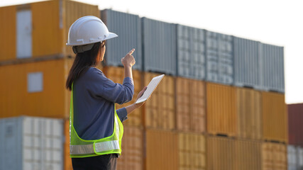 Worker woman checking and control loading containers box from cargo