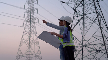Two specialist electrical engineer working near to High voltage tower.