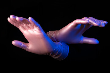 Hands emerging from the darkness. Pantomime with rubber gloves. Spot lighting. Magician.