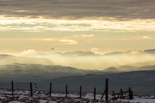 Looking towards the Lake District hills from Hartside in the North Pennines at sunset, with an RAF trainer plane flying over.