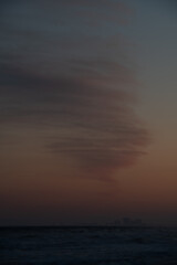 twirly clouds over the sunset at the beach