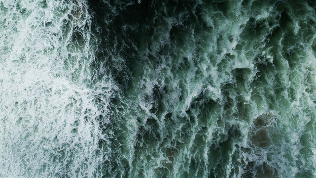 Texture and patterns of the Pacific Ocean crashing into shore