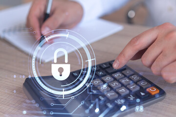 A businessman computing probability of risks in cyber security protection using calculator. Padlock...
