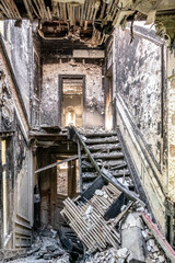 Staircase of burnt down house, heavy decay
