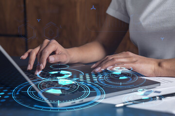 Naklejka premium Woman hands typing the keyboard to create innovative software to change the world and provide a completely new service. Close up shot. Hologram tech graphs. Concept of Dev team. Casual wear.