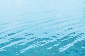 Water surface of swimming pool with sun reflection