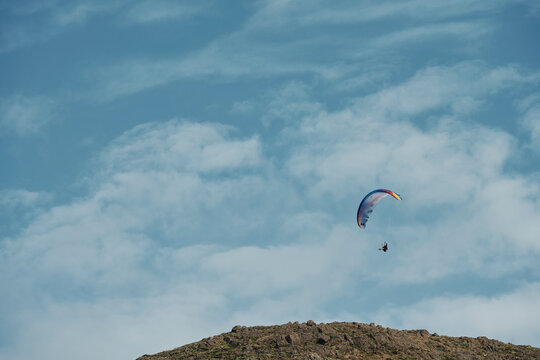Skydiver flying in blue sky in sunny day