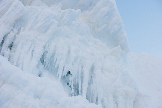 Frozen icicles adorn the side of a mountain.