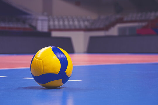 Volleyball ball on blurred wooden parquet background. Banner, space for text, close up view with details.