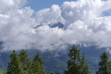 Cumulus clouds revealing the Alpine mountain range, Piedmont region, northwestern Italy