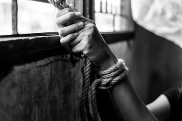 Asian young girl trafficking, kidnap or abduct Detainee tied rope at arms She get hopeless,...