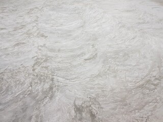 The stains of cement on the polished concrete floor.