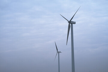 Fototapeta premium wind power turbine with white cloud sky background 