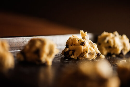 chocolate chip cookie dough on a stainless steal cookie sheet