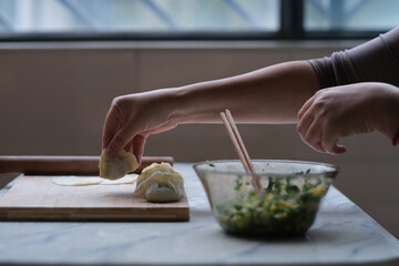 close up hand making dumpling. Traditional Chinese food during Chinese new year. Chinese culture concept