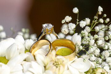wedding rings on a bouquet of flowers