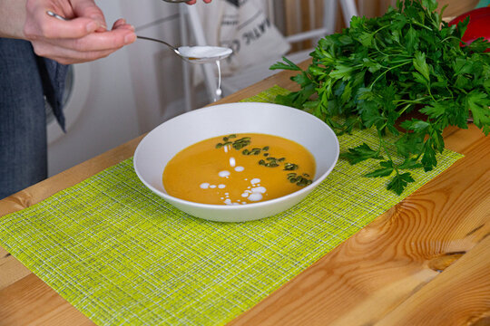 Preparing chicken stock with vegetables bouillon in a pot. Black chalkboard as background.