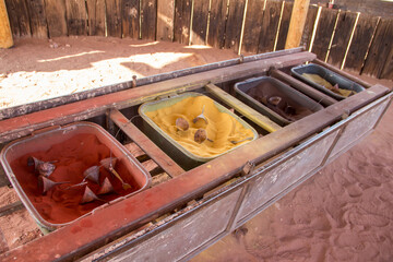 Various colored sand in boxes in the dessert