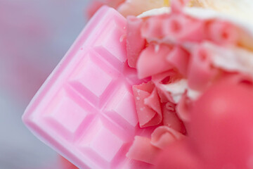 Sweet pink ruby chocolate bar. Grated chocolate close up.