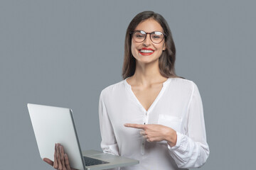 Young rejoicing business woman showing laptop