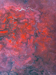 Beautiful abstract background. Pouring acrylic paint on canvas.