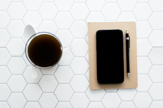Flatlay - Notebook, Coffee, Pen on White Hexagon Tile