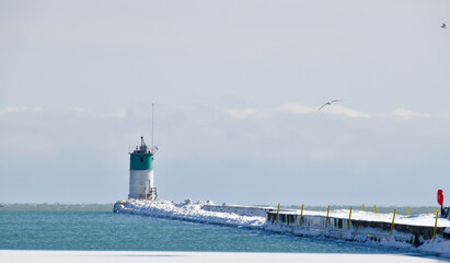 snow covered winter lake shore lighthouse