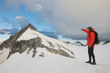 Hiker points out the route ahead towards the summit of Cypress Peak.