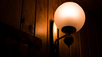 Outdoor exterior small  lamp on wooden wall