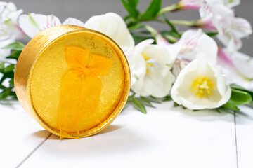 composition of a gift box, and a bouquet of flowers. holiday and congratulations concept