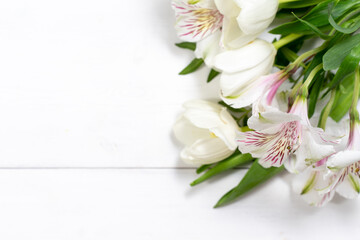 bouquet of spring white flowers on a white wooden background with place for text. mock up with copy space
