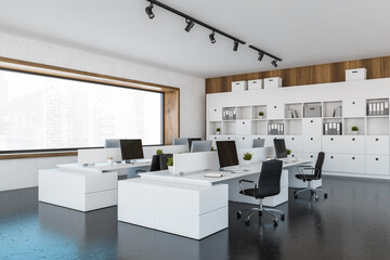 White office room with armchairs and computers on tables and shelves