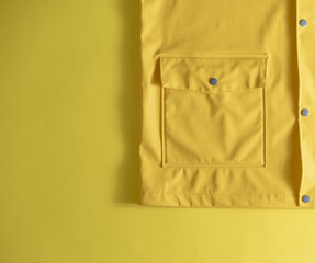 Yellow raincoat on a yellow background