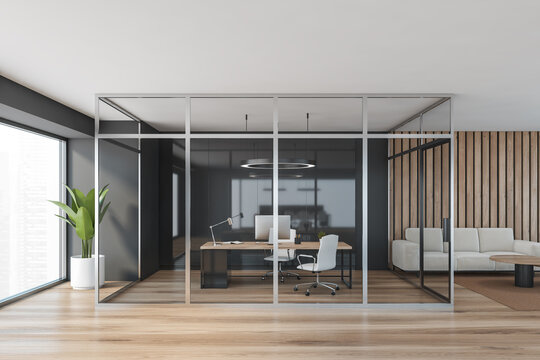 Wooden office consulting room behind glass doors near window
