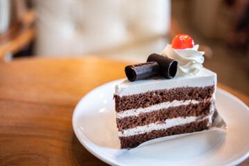 closeup sweet delicious dark chocolate with cream and strawberry jelly and berry jam in coffee cafe, very fresh cake which bake from oven and slice for serve
