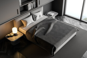 Top view of dark grey bedroom, bed with linens near window