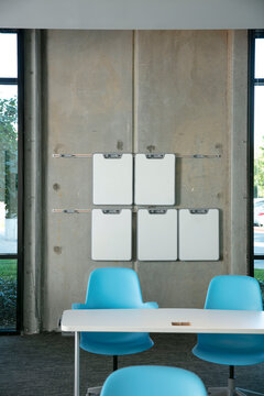 A classroom with white dry erase boards hang from wall