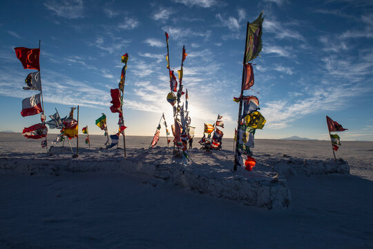 international flags planted on the salt flats of Uyuni in Bolivia