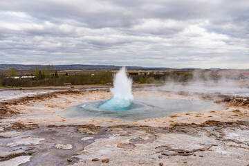Eruption of Strokkur Geyser in Iceland.  Fountain Geyser throws azure water every few minutes (part 2)