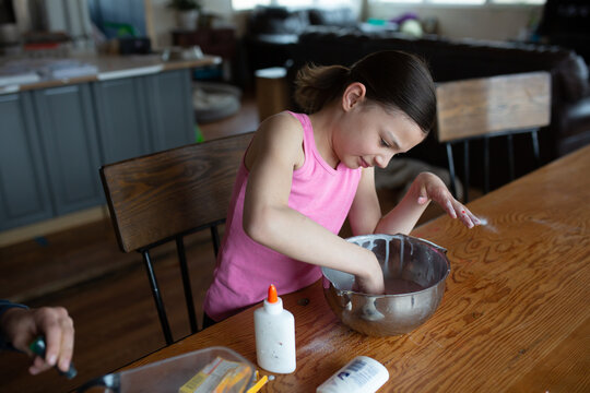 Girl mixing slime with her hands
