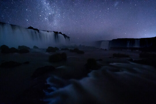 Beautiful landscape of big waterfall under a clear sky full of stars