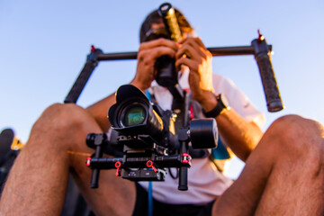 Videographer shooting using a Gimbal stabilizer with DSLR