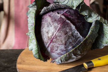 Fresh organic red cabbage on wooden table.