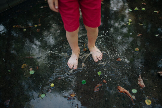 boy's feet in a puddle