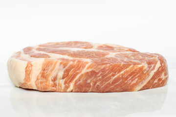 Raw pork neck on a cutting marble board.