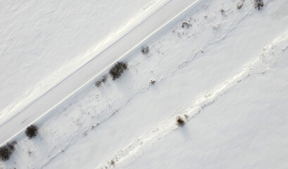 Top view of rural snowy road in winter
